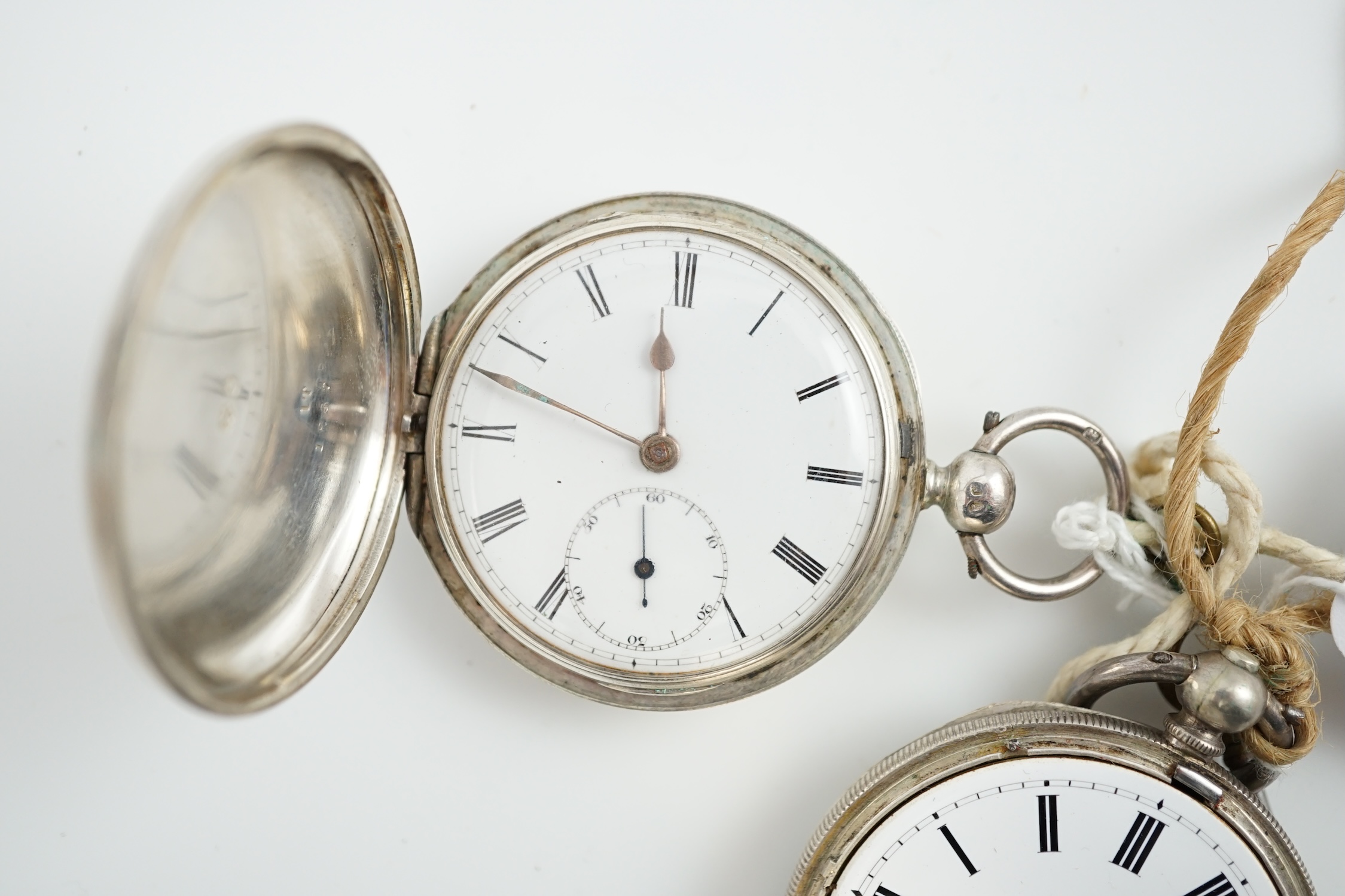 A Victorian silver hunter keywind pocket watch and an engine turned white metal pocket watch.